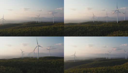 航拍的风车旋转的力量，风力和产生可再生能源的绿色生态方式，以地球上的日落。高清在线视频素材下载
