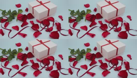 情人节快乐。礼物。红玫瑰花瓣和红丝带高清在线视频素材下载