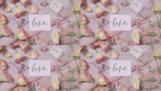 爱情卡片在大理石桌子上近粉红色的花俯视图放大高清在线视频素材下载