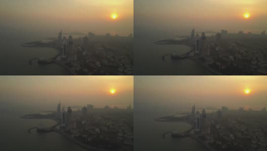 日落时分青岛市著名的海滩湾现代海宫鸟瞰4k中国高清在线视频素材下载