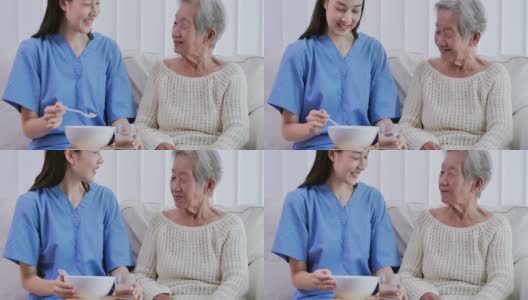 亚洲年轻女性护理护士帮助喂早餐病人亚洲老祖母82岁在养老院。高清在线视频素材下载
