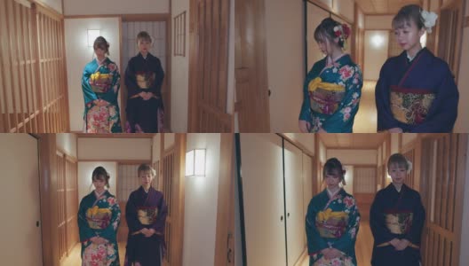 两个穿着Furisode和服的年轻女子一起走在日本旅馆的走廊上高清在线视频素材下载