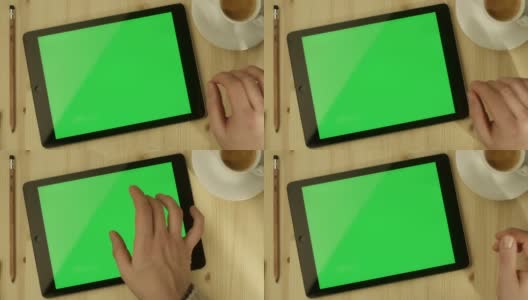 桌上放着绿色屏幕的平板电脑高清在线视频素材下载