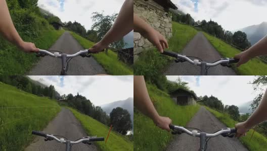 骑自行车的人沿着乡村小路穿过村庄高清在线视频素材下载