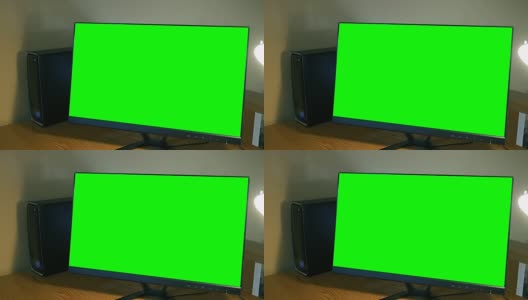 绿屏电脑显示器坐在办公桌上的家庭办公室ALT高清在线视频素材下载