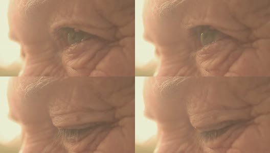 特写照片上的眼睛老人与太阳背光:看，皱纹的人高清在线视频素材下载
