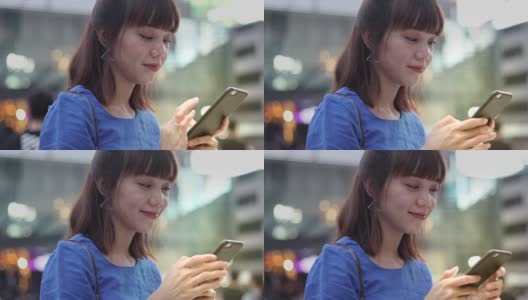 年轻的亚洲女性使用智能手机高清在线视频素材下载