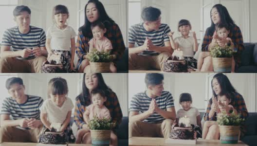 亚洲家庭在客厅为小女儿庆祝生日(慢镜头)高清在线视频素材下载