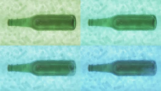 一个啤酒瓶躺在冰里，被不同的颜色照亮高清在线视频素材下载