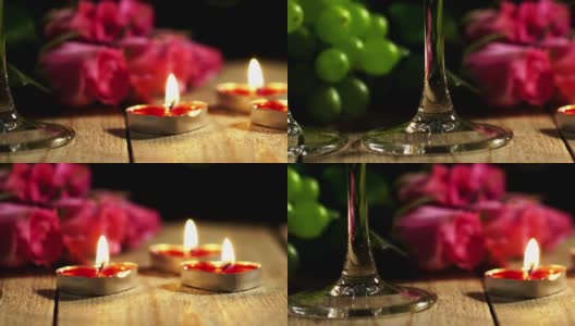 优雅的静物在宏观上由燃烧的蜡烛和鲜花躺在葡萄与酒杯高清在线视频素材下载