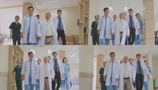 一组由医生、护士和助理组成的亚洲团队走过医院的走廊。有专业医疗经验的医生在室内行走，为拯救生命而工作。缓慢的运动。高清在线视频素材下载