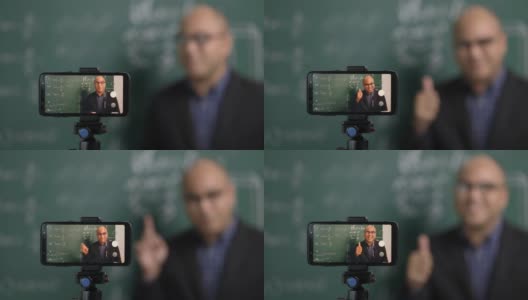 印度年轻教师男子通过智能手机进行在线视频会议直播。亚洲数学教师在线授课，供学生在线学习。高清在线视频素材下载