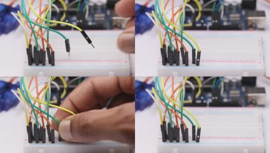 连接跳线到无焊面包板，显示了电子项目制作的概念高清在线视频素材下载