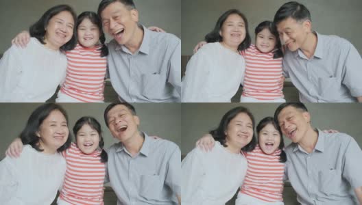 亚洲资深祖父母和孙女坐在床上拥抱可爱的一起与爱在床上的家室内背景高清在线视频素材下载