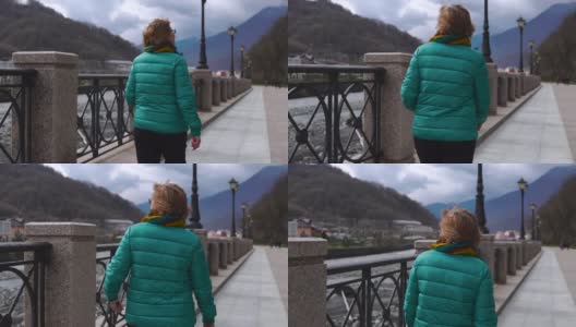一个年长女人白天走路的样子。高原自然场景高清在线视频素材下载