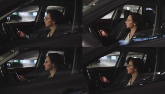 女商人坐在车里查看智能手机上的信息高清在线视频素材下载