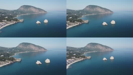 克里米亚，GURZUF -鸟瞰著名的岩石Adalary，两个双悬崖与山的边缘Au-Dag在早春的早晨在克里米亚半岛的南海岸。本空间高清在线视频素材下载