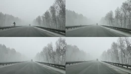在大雪的冬天，通过高速公路上汽车的挡风玻璃看高清在线视频素材下载