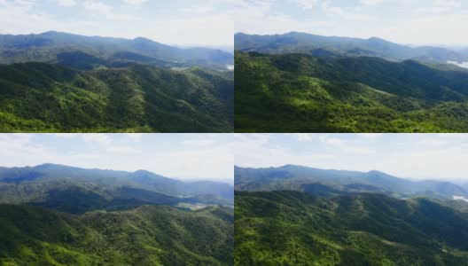 鸟瞰图，绿色的山丘和山脉在蓝天和白云的衬托下高清在线视频素材下载