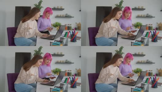 积极的女大学生在宿舍用笔记本电脑一起学习高清在线视频素材下载