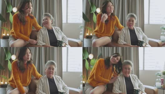 幸福亚洲家庭坦诚的女儿和儿子拥抱祖父母妈妈年长的妈妈舒适放松在沙发沙发惊喜访问在家里的客厅，一起拥抱快乐的亚洲家庭在家里高清在线视频素材下载