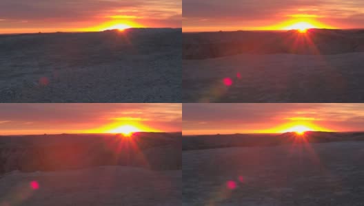 AERIAL: Badlands公园砂岩山背后令人惊叹的红色日落高清在线视频素材下载
