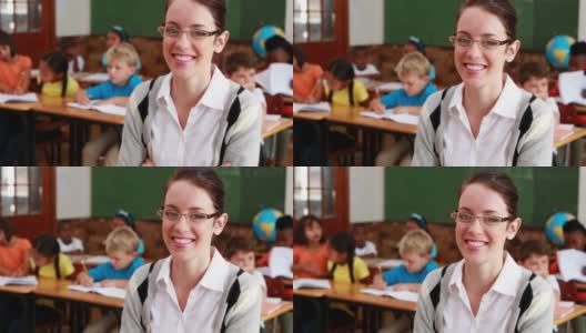 Pretty teacher smiling at camera高清在线视频素材下载