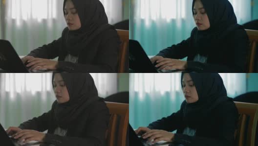 东南亚的头巾商务女性穿着西装努力工作用笔记本电脑在家里有两种色调高清在线视频素材下载