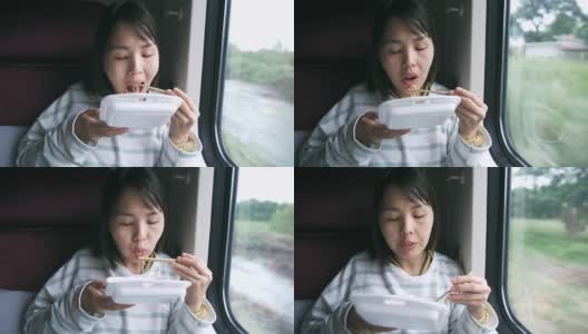 在火车上吃面条的女人高清在线视频素材下载