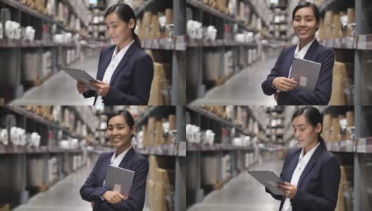 肖像女企业主使用数字平板电脑在仓库，转向相机，信心高清在线视频素材下载