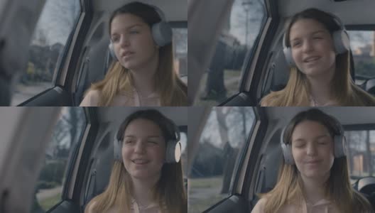 十几岁的女孩边开车边跟着音乐唱歌高清在线视频素材下载