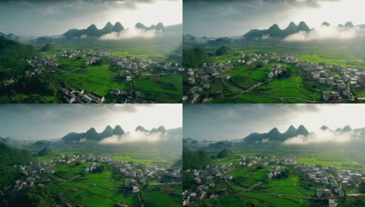 鸟瞰喀斯特山峰森林(万峰林)中的村庄和稻田，贵州，中国。高清在线视频素材下载