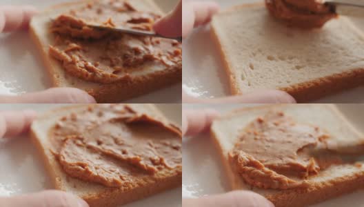 把花生酱涂在烤面包上，做三明治高清在线视频素材下载