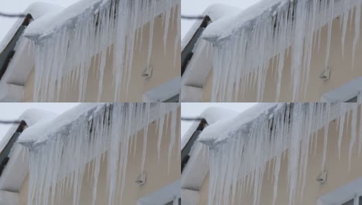 冬天，屋顶上有大量正在融化的冰柱高清在线视频素材下载