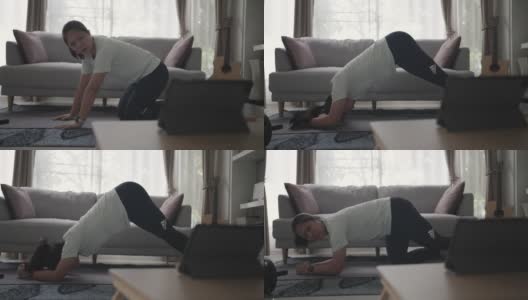 女性在家锻炼和练习用平板电脑燃烧脂肪高清在线视频素材下载
