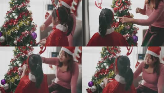 妈妈和孩子装饰圣诞树高清在线视频素材下载