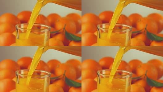 橙汁倒进玻璃杯，慢动作高清在线视频素材下载