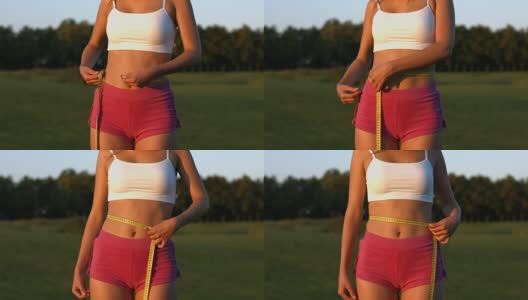 女运动员自然测量腰围。高清在线视频素材下载