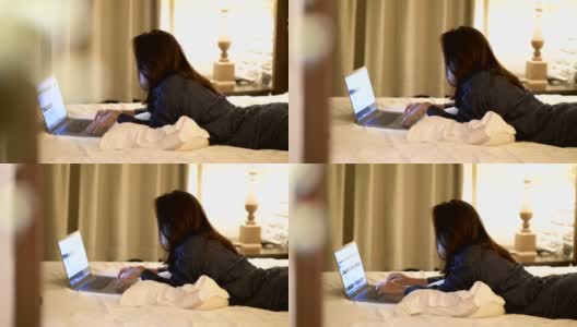 卧室:年轻女子晚上在平板电脑上冲浪的特写高清在线视频素材下载
