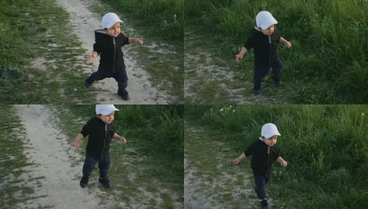 孩子穿着夹克，戴着兜帽，在田野里跑着高清在线视频素材下载