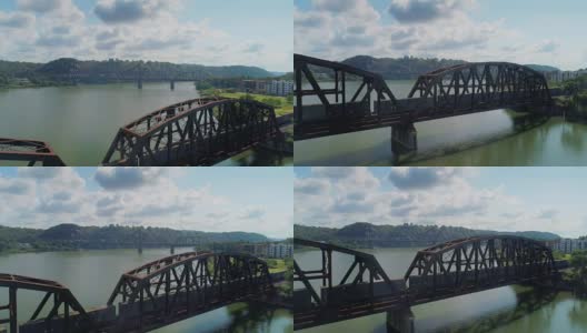 在俄亥俄州河上的铁路桥上的火车的反向空中拍摄高清在线视频素材下载