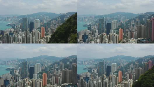 阳光明媚的一天香港市区风景维多利亚港市中心山空中全景4k高清在线视频素材下载