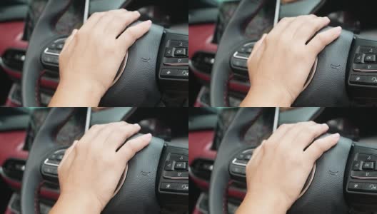 当驾驶时，靠近方向盘上推喇叭的手。高清在线视频素材下载