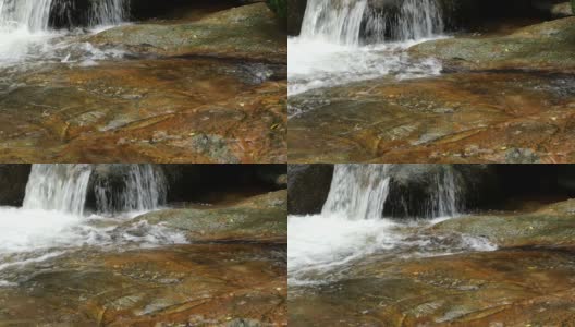 从泰国苏梅岛的岩石中流过的小河，欣拉德瀑布高清在线视频素材下载