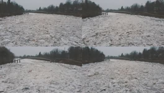 巨大的冰块漂流在拉脱维亚的食人河。空中龙拍摄雪城日。春天这条河上的交通堵塞。一大群移动的冰块高清在线视频素材下载