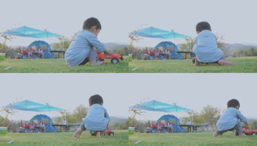 小男孩在草坪上玩玩具。高清在线视频素材下载