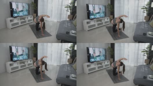 亚洲孕妇穿着运动装在家瑜伽垫上做运动训练。高清在线视频素材下载