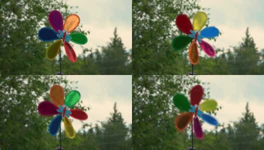 彩色风车在不同的旋转运动。风向标在自然背景上。风向标在移动高清在线视频素材下载
