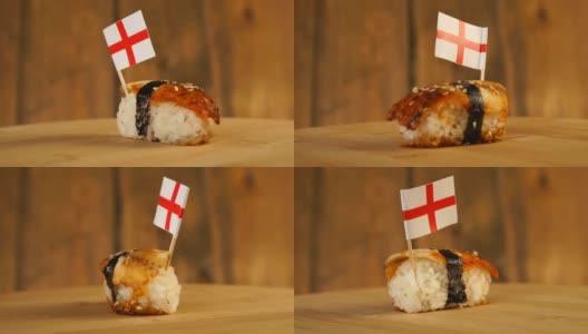 寿司配上鱼、米饭、海草和英国小旗放在上面，在木制的转盘上旋转。高清在线视频素材下载