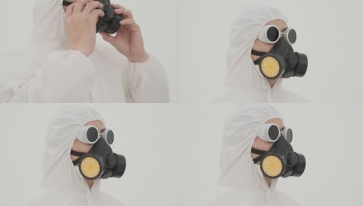 特写的人在防护服上戴着防毒面具自己。在白色背景上拍摄。高清在线视频素材下载